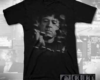 May include: Black V-neck t-shirt with a black and white image of a man holding a chain. The shirt has the text "CULT RATED" in a rectangular box at the bottom right.