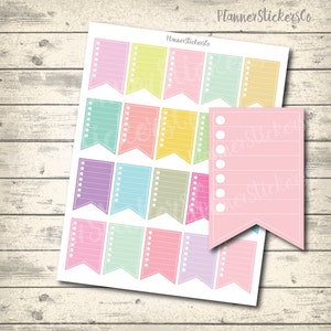 Op de afbeelding: Een vel pastelkleurige planner stickers met een banner vorm. De stickers hebben een witte omtrek en witte gestippelde lijnen. De stickers zijn bedoeld voor het schrijven van notities of to-do-lijsten.