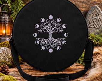 May include: A round black crossbody bag featuring a white embroidered design of a tree with bare branches surrounded by a circular arrangement of moon phases. The bag has a black adjustable strap and a zipper closure along the top edge.