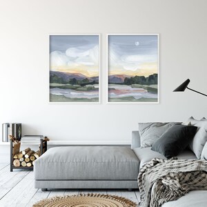 a living room with two paintings on the wall
