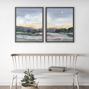 two paintings on a wall above a bench