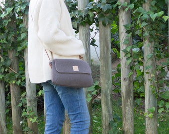 Small brown winter crossbody bag with long strap for women.