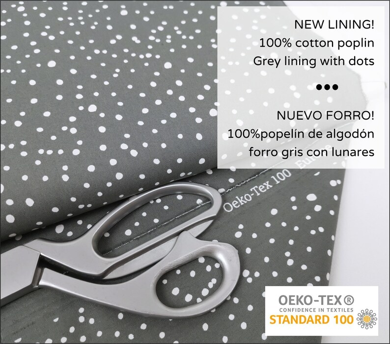 May include: Gray cotton poplin fabric with white dots. The fabric is folded in half and a pair of silver scissors are on top of the fabric. The fabric has a label that says "Oeko-Tex 100" and "NEW LINING! 100% cotton poplin Grey lining with dots" and "NUEVO FORRO! 100% popel&iacute;n de algod&oacute;n forro gris con lunares". The fabric also has a label that says "OEKO-TEX&reg; CONFIDENCE IN TEXTILES STANDARD 100".