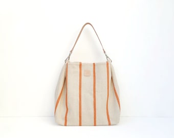 Medium shoulder bag with zipper. Casual canvas tote bag with leather strap. Striped hobo bag orange and beige for summer.