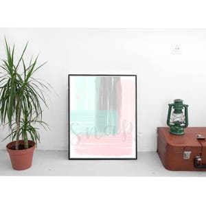 May include: Abstract art print in a black frame with a pink, gray, and teal color scheme. The print features brushstrokes and abstract shapes.
