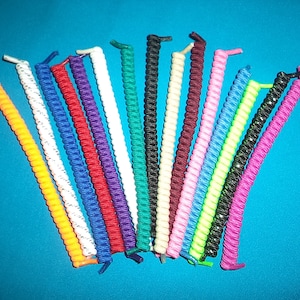 May include: Assortment of colorful shoelace replacements. The laces are made of a stretchy, coiled material and come in a variety of colors, including orange, white, blue, red, purple, green, black, pink, and lime green.
