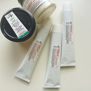 May include: Three tubes of natural toothpaste with labels that read "Earth Natural Toothpaste - Turmeric Toothpaste - Propolis Aloe Vera - Prevention of gingivitis and plaque".  One jar of natural toothpaste with a label that reads "Earth Natural Toothpaste (Mint Spearmint)".