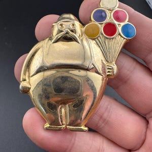 Vintage 1980s gold tone coloured enamelled circus clown with balloons brooch