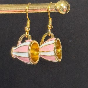 May include: Gold tone earrings with pink and white striped teacup charms.