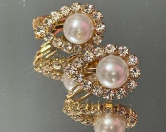 May include: A pair of gold-tone earrings with a pearl and clear rhinestone accents.