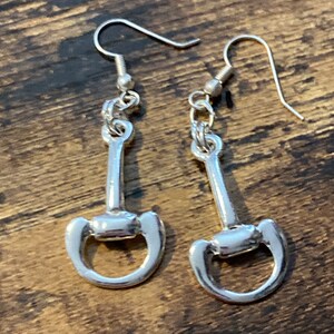 Pair of bright silver tone snaffle horse bit stirrup drop earrings