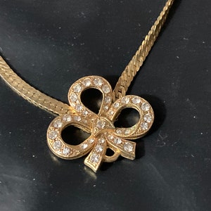 Signed Joan Rivers gold plated clear diamanté bow pendant necklace