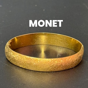 designer MONET signed brushed gold tone 1cm wide hinged clamper bangle bracelet