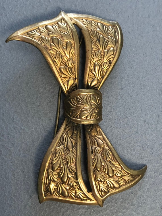 Brass brooch on sale