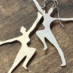 Unmarked silver 7cm long Art Deco dancing lady drop earrings pierced ears white metal