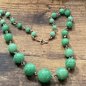 Art Deco czech gold tone metal necklace with green peking glass or ceramic stones