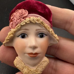 Vintage ceramic flapper face brooch: art deco with red velvet hat