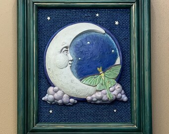 Hombre en la Luna, cuadro 3D con polilla luna y cara de luna creciente sonriente