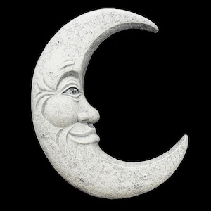 May include: A crescent moon wall plaque featuring a textured, off-white stone-like finish. The moon has a carved human-like face in profile, including a visible eye, a nose, and a smiling mouth, with small star-shaped indentations across the surface.