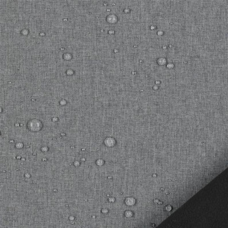 May include: A grey fabric with a visible woven texture featuring numerous clear water droplets scattered across the surface. A solid black corner section is visible in the bottom right, contrasting with the textured grey material.