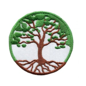 May include: Circular embroidered patch with a tree design. The tree has a brown trunk and roots, with green leaves and a green border. The patch is set against a white background. Suitable for jackets, bags, or other fabric items.