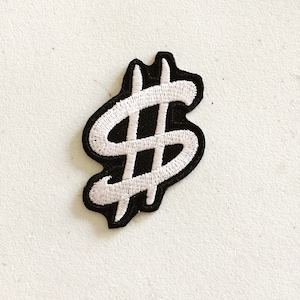 May include: White embroidered dollar sign patch on a black background.