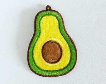 May include: A green and yellow embroidered avocado patch with a brown seed.