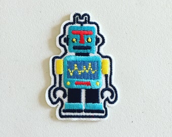 May include: A blue and yellow embroidered robot patch with a red antenna and yellow eyes. The robot has a blue screen with a yellow wavy line on it.