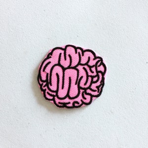 May include: Pink embroidered brain patch with black outline.