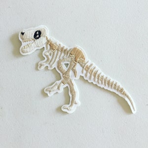 Parche termoadhesivo de esqueleto de velociraptor: Insignia de dinosaurio