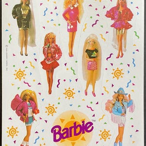 May include: A sheet of colorful stickers featuring different Barbie dolls in various outfits. The stickers are on a white background with a yellow sun and confetti designs. The text "Barbie" is printed in purple on a yellow sun.