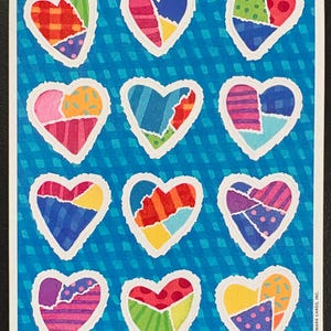 May include: A sheet of colorful heart stickers with a blue background. Each heart is a patchwork of different patterns and colors, including red, pink, blue, and yellow. The stickers have a white border and are arranged in a grid pattern.