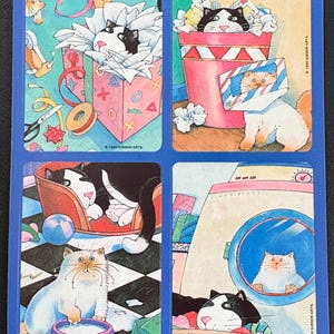 May include: A sheet of four illustrated cat images. One cat is in a gift box, another in a trash can, a third in a bed, and the last in a washing machine. The images are on a blue background. The text "© 1990 GIBSON GRTS." is present.
