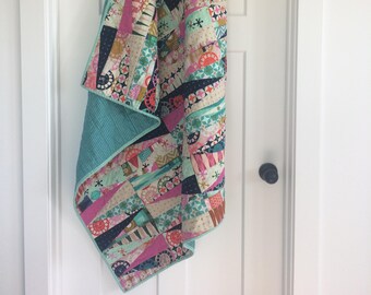 Playful diamond baby quilt