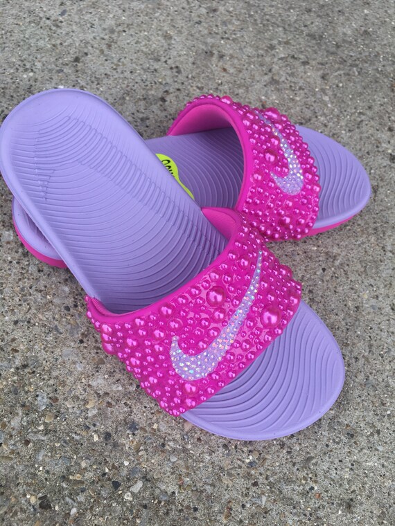 pink and purple nike slides