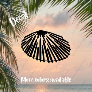May include: Black seashell decal with the word "Decal" in white. The text "More colors available" is also present. The image is set against a sunset backdrop with palm fronds in the foreground.