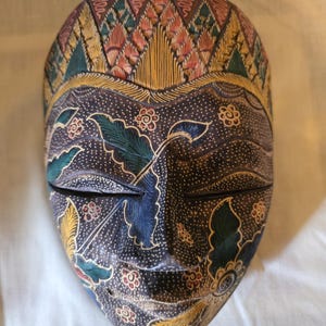 Hand Carved and Painted Indonesian Batik Wooden Mask. Styled as a Topeng from Bali and Java and ready to hang on your wall. Albesia Wood.