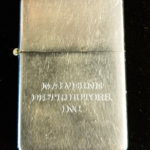May include: Silver lighter with the inscription "Mayberry Distributors, Inc."