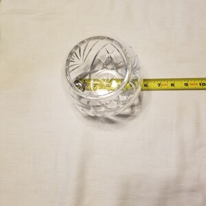May include: A clear glass bowl with a cut glass design. The bowl is approximately 6 inches in diameter.