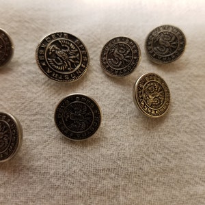 May include: Eight silver and gold-toned buttons with a raised design of a two-headed eagle and the text "DEVS SPES NOSTRA" around the eagle.