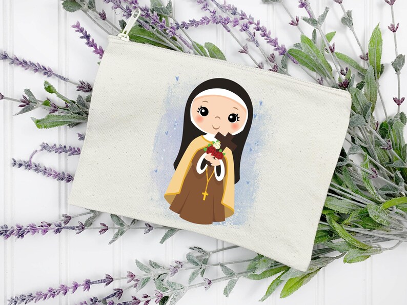 May include: A white canvas zippered pouch with a colorful illustration of a young girl in a brown habit holding a bouquet of flowers and a cross. The background is a light blue watercolor wash with white dots.