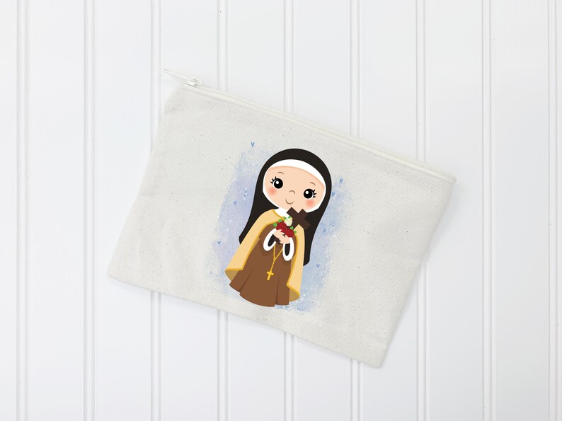 May include: A white canvas zippered pouch with a colorful illustration of a young girl wearing a brown and white habit and holding a bouquet of flowers. The girl has dark hair and brown eyes.