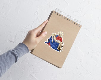 May include: A sticker featuring a religious image of a woman in a blue robe holding a man in her arms. The woman has a halo and is wearing a red robe. The man is wearing a white robe and has a halo. The sticker is on a brown background.