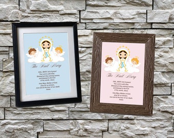 May include: Two framed prints with a light blue and pink background. Each print features a cartoon image of the Virgin Mary with two angels. The text "The Hail Mary" is printed below the image. The text of the Hail Mary prayer is printed below the title.