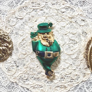 May include: A set of three ceramic mugs with a speckled, matte finish. Each mug features a different color: light blue, cream, and gray. The mugs have a simple, modern design, suitable for coffee or tea.