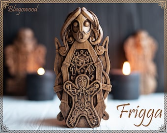 May include: A wooden carving of the Norse goddess Frigg, with intricate details and a smaller figure of a person inside. The carving is labeled "Frigg" and "Blagowood".