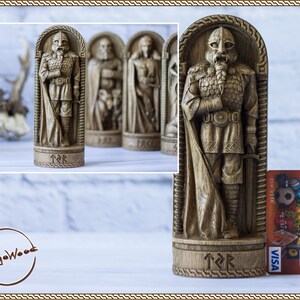 May include: A wooden carving of a Viking warrior in a detailed, intricate style. The warrior is wearing armor and a cloak, and is holding a sword. The carving is on a wooden base with runes carved into it.