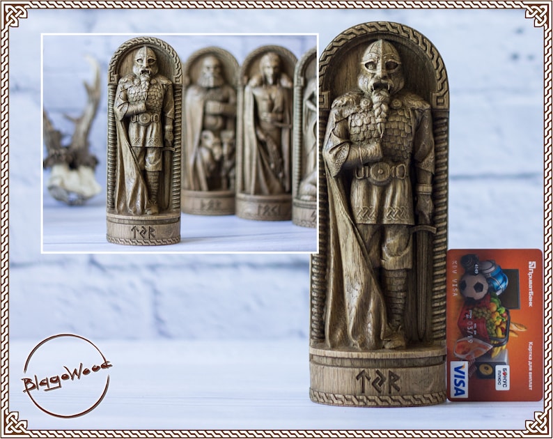 May include: A wooden carving of a Viking warrior in a detailed, intricate style. The warrior is wearing armor and a cloak, and is holding a sword. The carving is on a wooden base with runes carved into it.