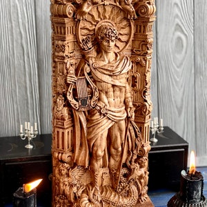 May include: A wooden sculpture of a male figure with a lyre and a staff, standing on a base with a dragon design. The sculpture is surrounded by intricate carvings of flowers, leaves, and other decorative elements.