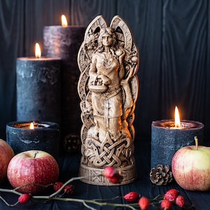 Idunn goddess of youth in Asatru, linked with Seidr Volva traditions. Idunn statue - keeper of apples. Norse statue of fertility and renewal